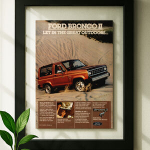 Framed original ford bronco ii ad in black floating frame on wall