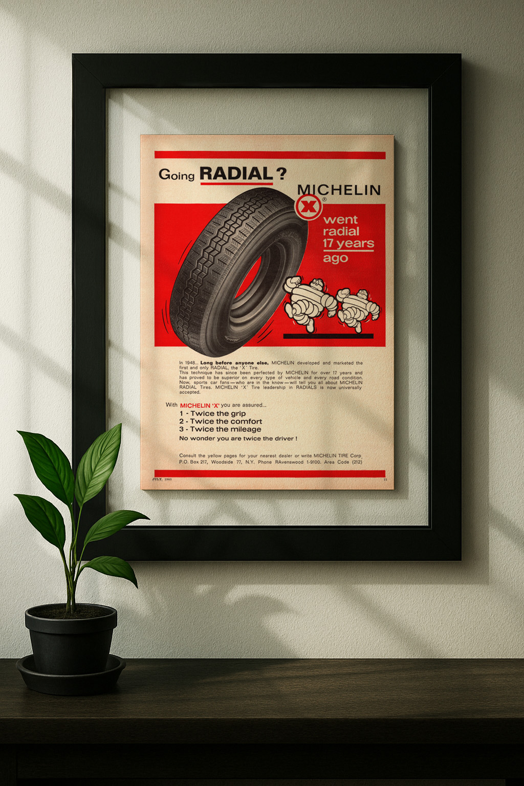 michelin x framed original ad in black floating frame on wall