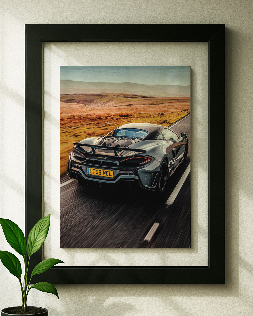 600lt mclaren framed original ad in black floating frame on wall