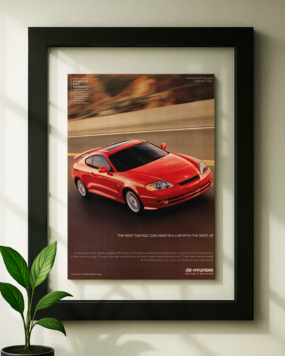 hyundai tiburon gt v6 framed original ad in black floating frame on wall
