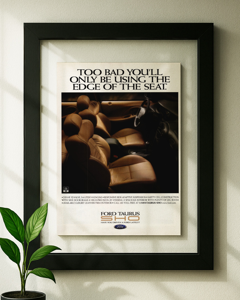 ford taurus sho framed original ad in black floating frame on wall